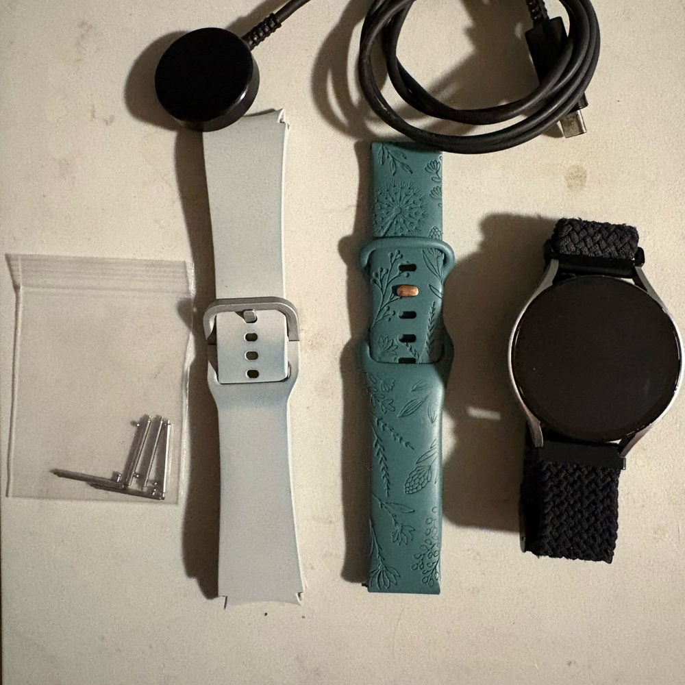 Samsung Smartwatch with Black, White, and Teal Bands